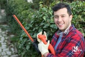 Man with blackdecker hh hedge trimmer